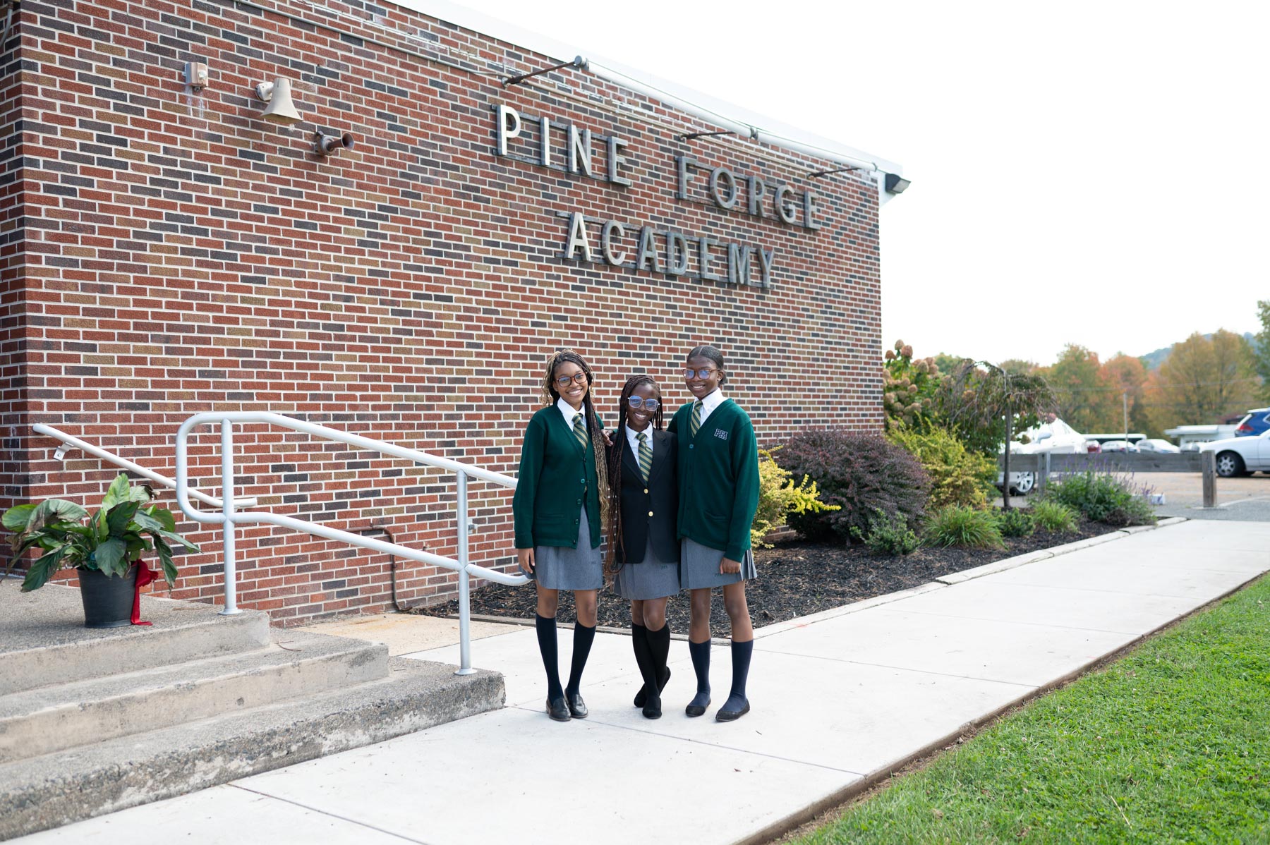 Three Girls Standing Outside the Main Academic Building